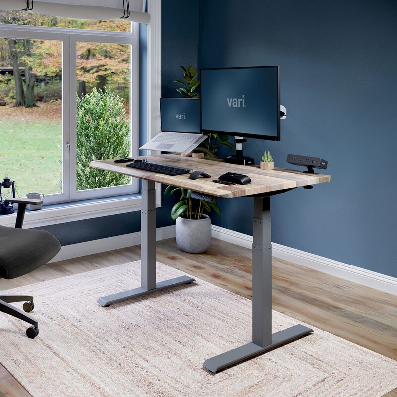 Electric Standing Desk with ComfortEdge in 48x30 Reclaimed Wood in raised position at home image number null
